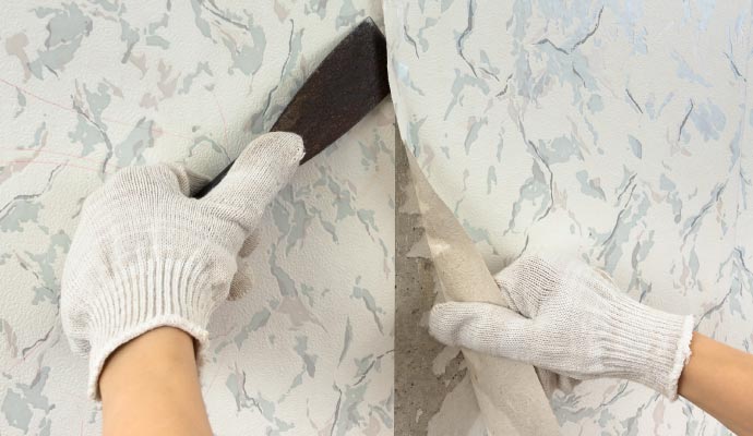 Old wallpaper removal A two-panel image showing a worker's gloved hands removing old wallpaper, first by lifting an edge with a scraper, then by peeling it off the wall.