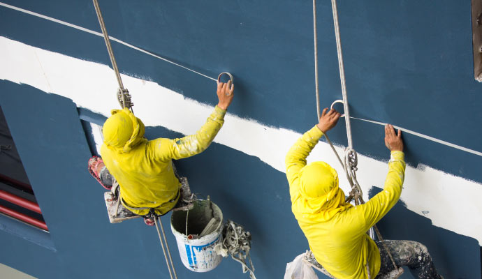 a team of experts painting commercial building