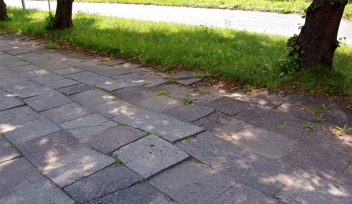 walkway with damaged and broken tiles