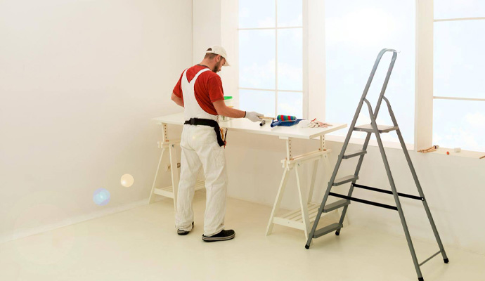 A professional in a room with painting equipments