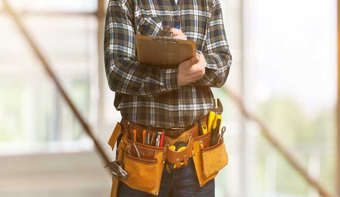 A handyman in standing on a construction site