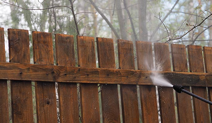 Wooden fence cleaning with pressure wash