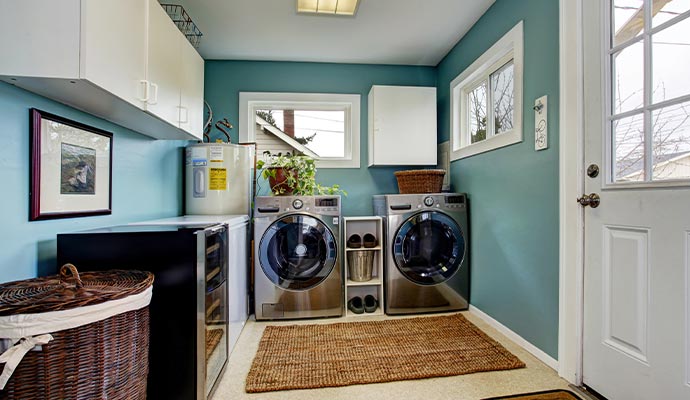 Professional worker painting laundry room